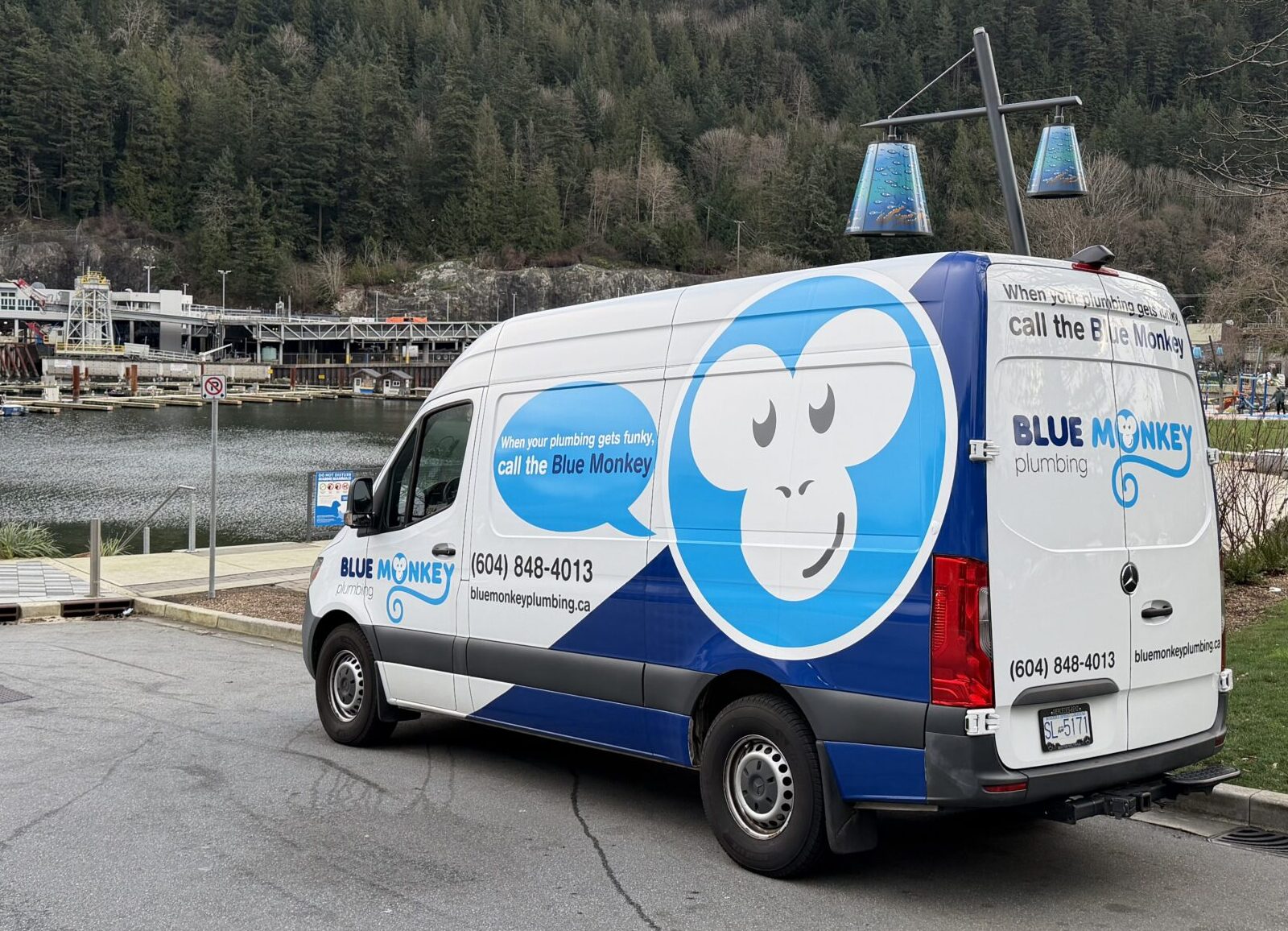 Blue Monkey Plumbing van parked in Horseshoe Bay with the bay in the background