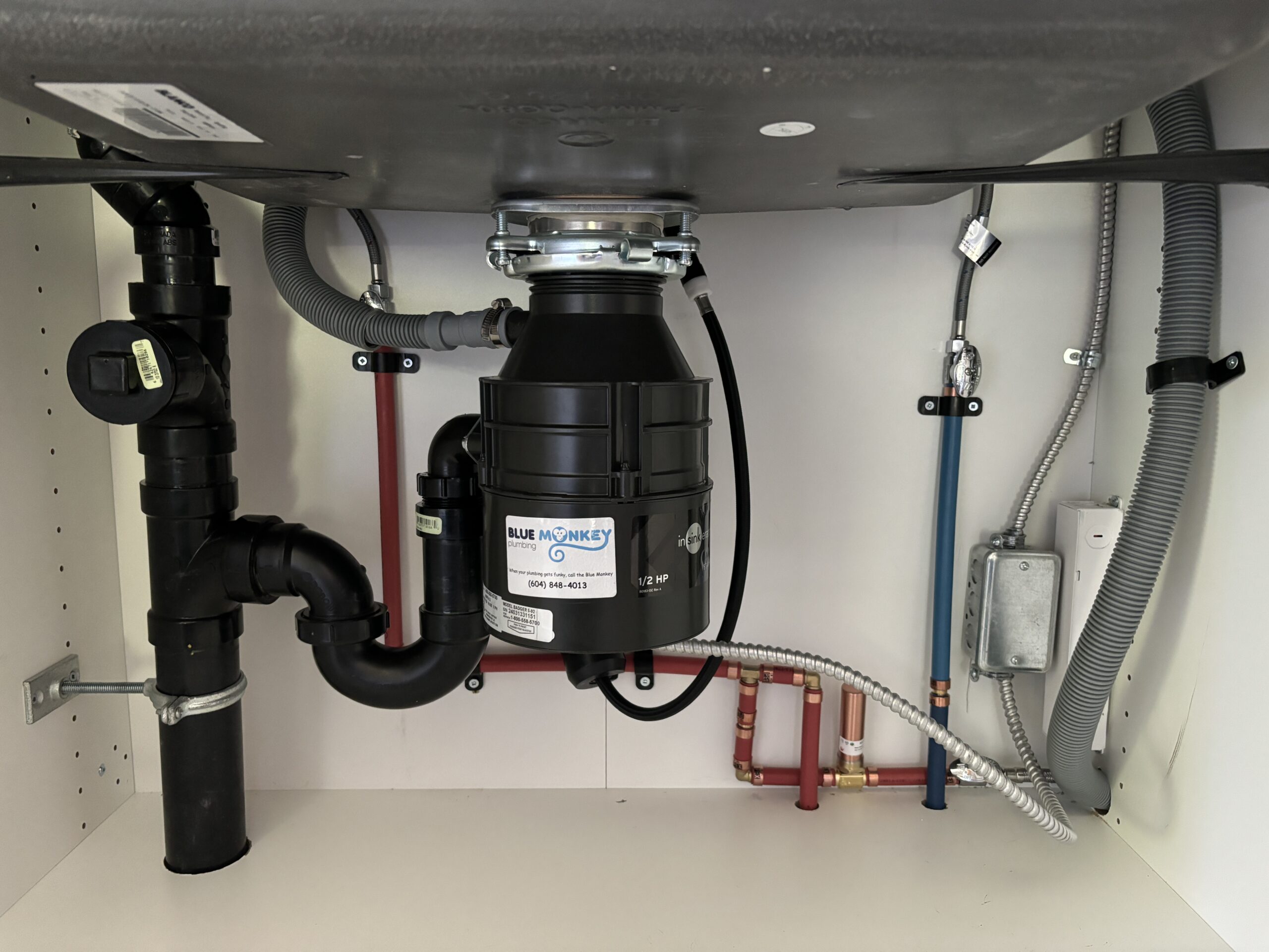 Garburator installed under kitchen sink in West Vancouver home